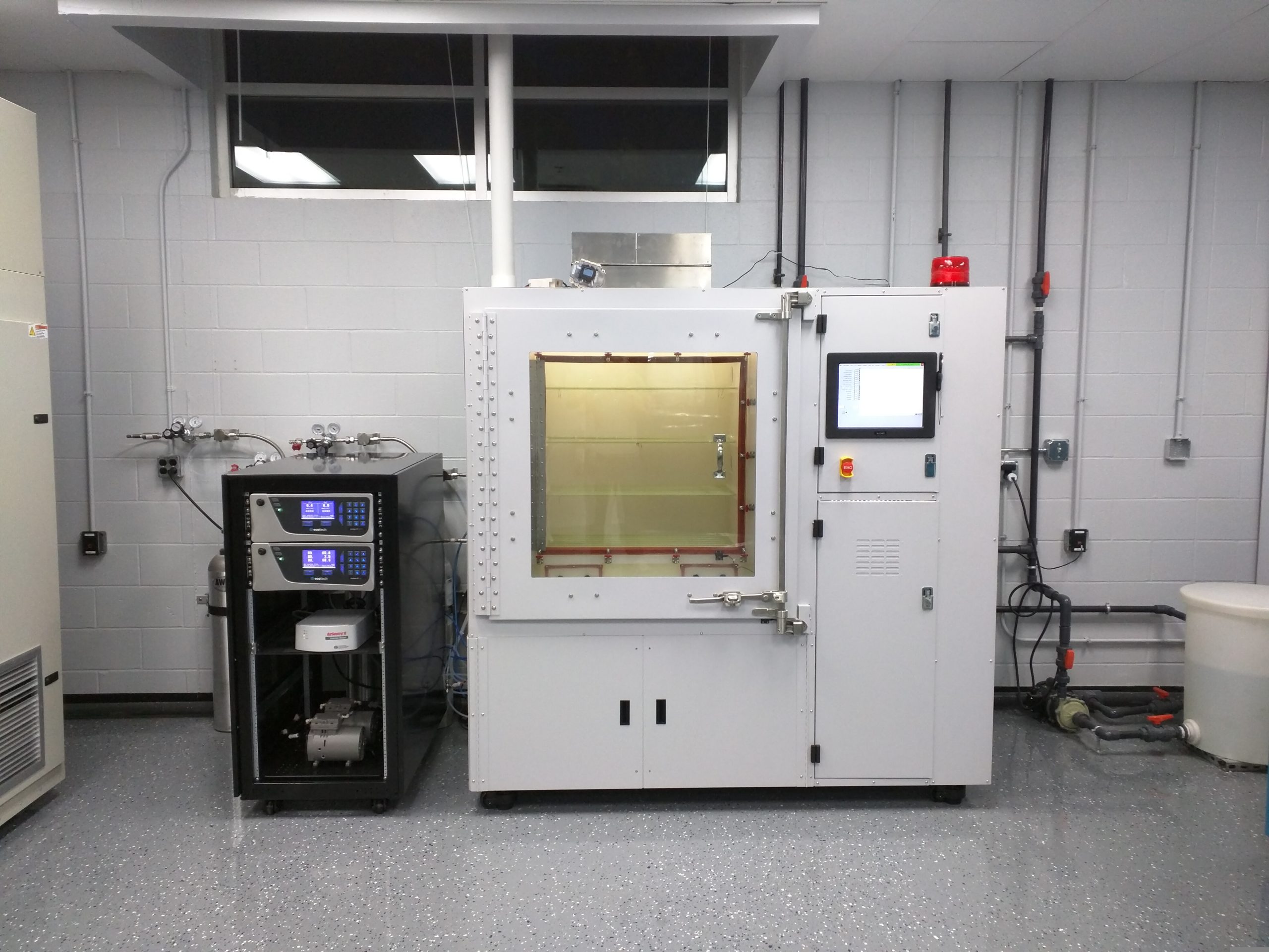 Environmental test chamber with viewing window and gas cylinder rack